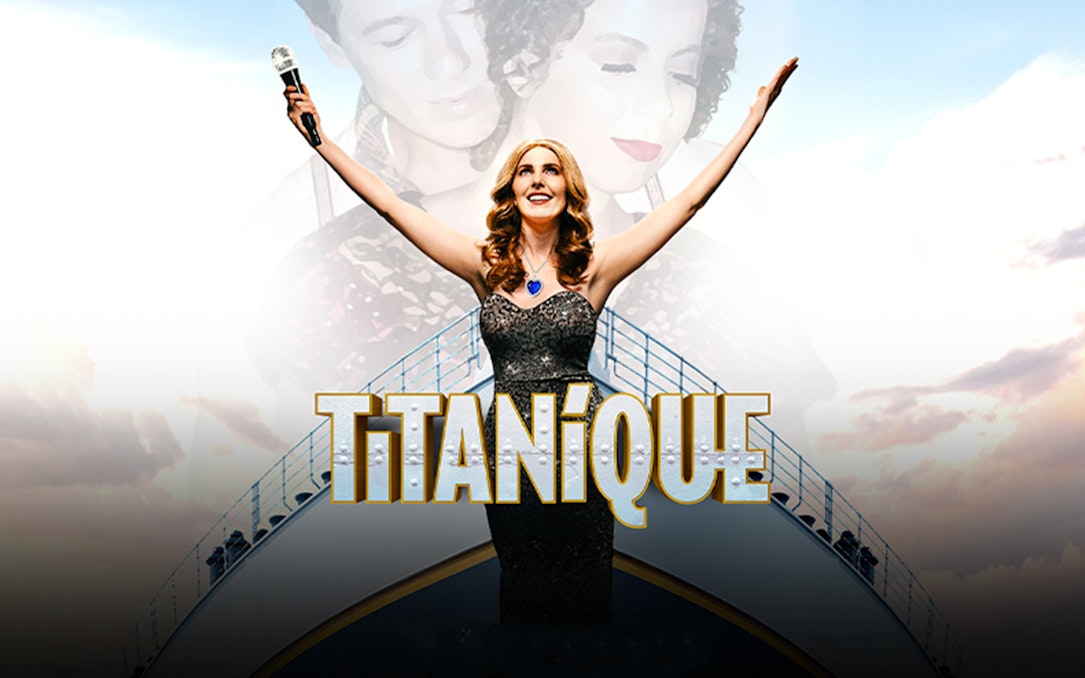 Performer on stage with arms raised, holding a microphone, with "Titanique" text.