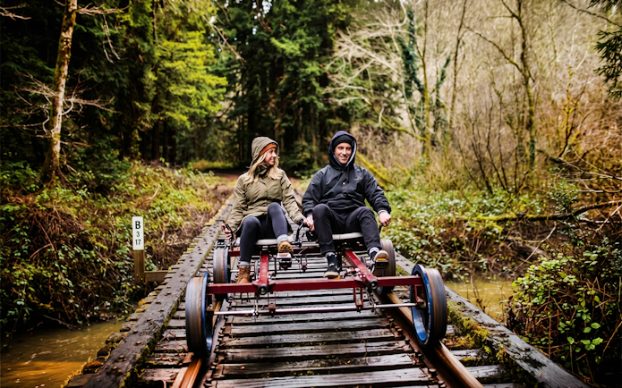Guests riding rail bike through redwoods in San Francisco.