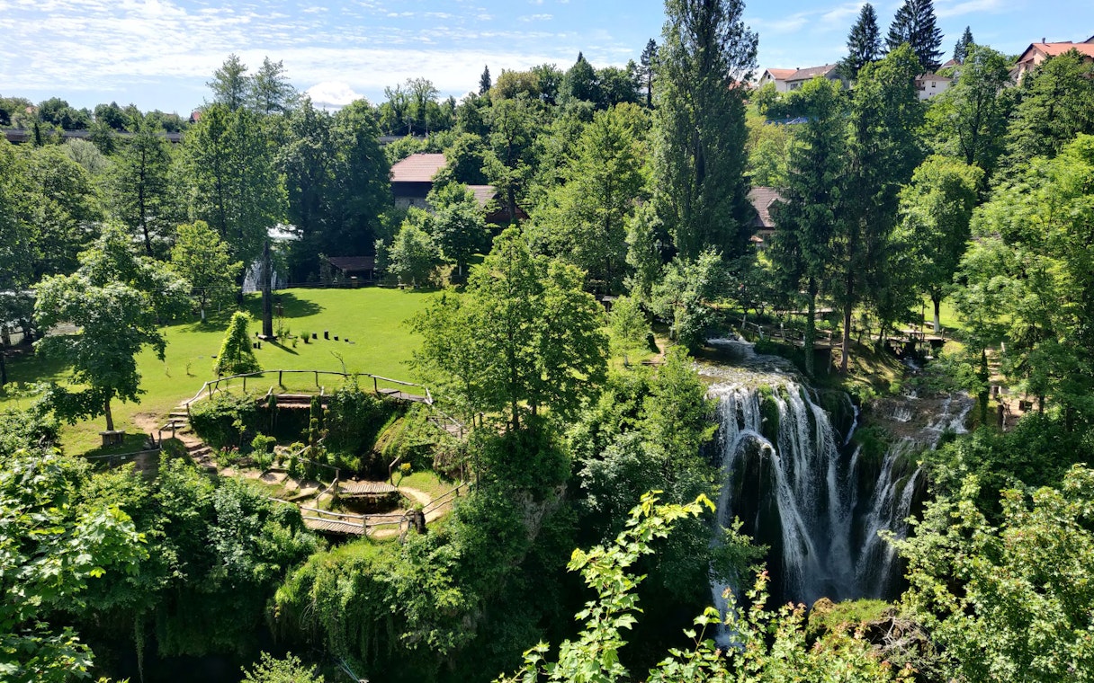 Waterfall and greenery in Rastoke Village, Croatia, part of the Plitvice Lakes tour.