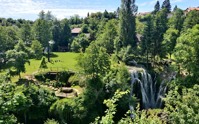 Waterfall and greenery in Rastoke Village, Croatia, part of the Plitvice Lakes tour.