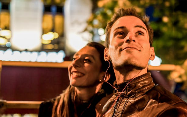 Couple enjoying Christmas lights on a night tour in San Francisco.