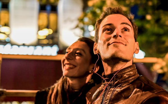 Couple enjoying Christmas lights on a night tour in San Francisco.