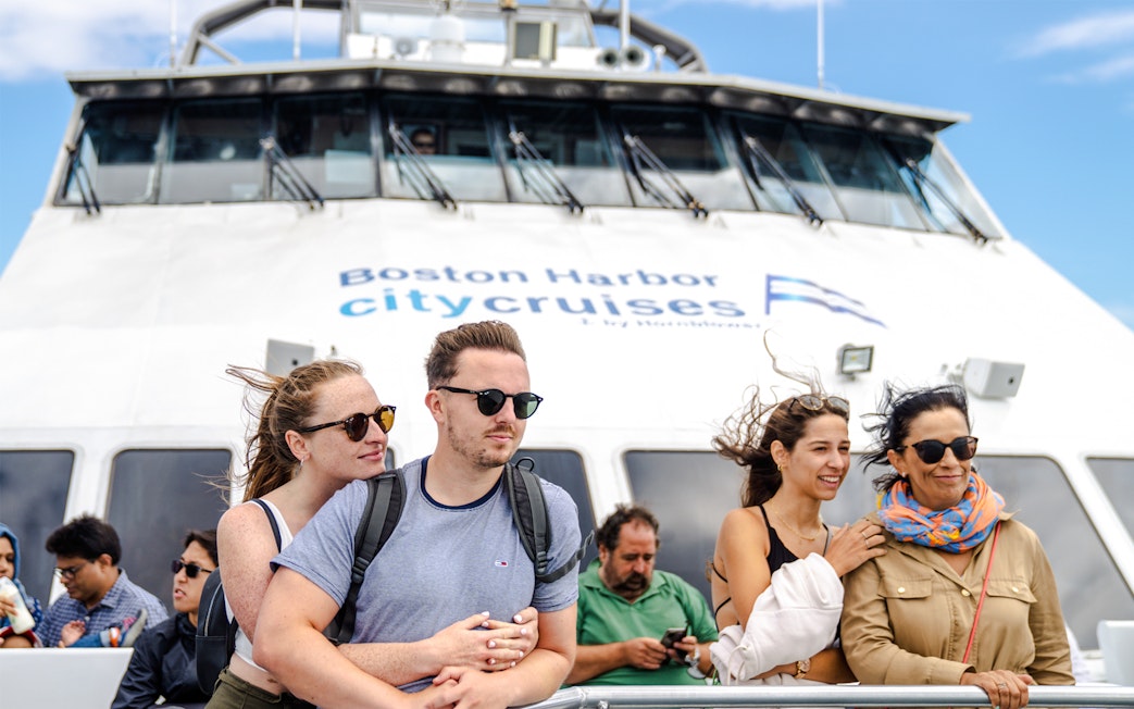 Guests enjoying a whale watching cruise on an England Aquarium tour.
