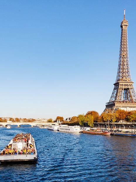 Cruise boat on the Seine River with Eiffel Tower in Paris.