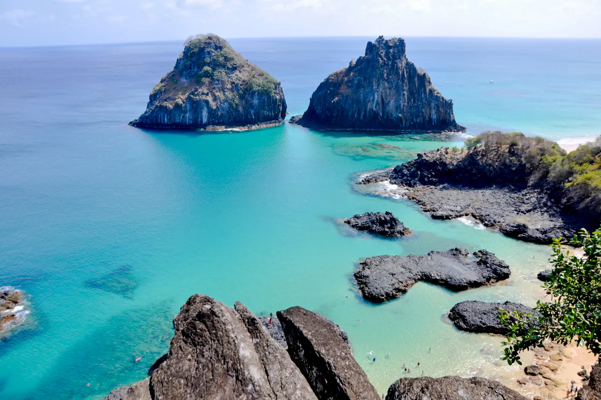 Turquoise waters and rocky formations at Sancho Beach, Noronha, Brazil.