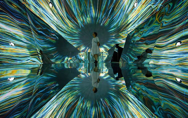 Visitor in immersive light installation at Phantom Vision, Light Art Museum, Budapest.