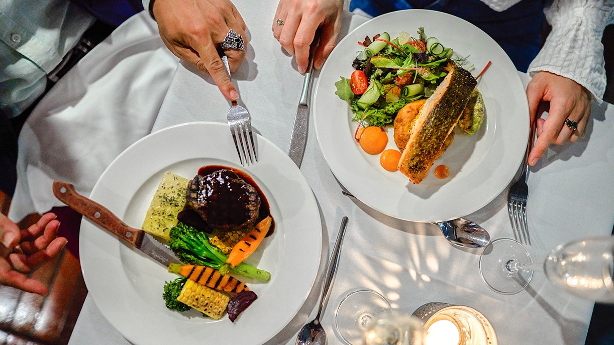 Dining on the Spirit of Melbourne Dinner Cruise with gourmet dishes and wine.
