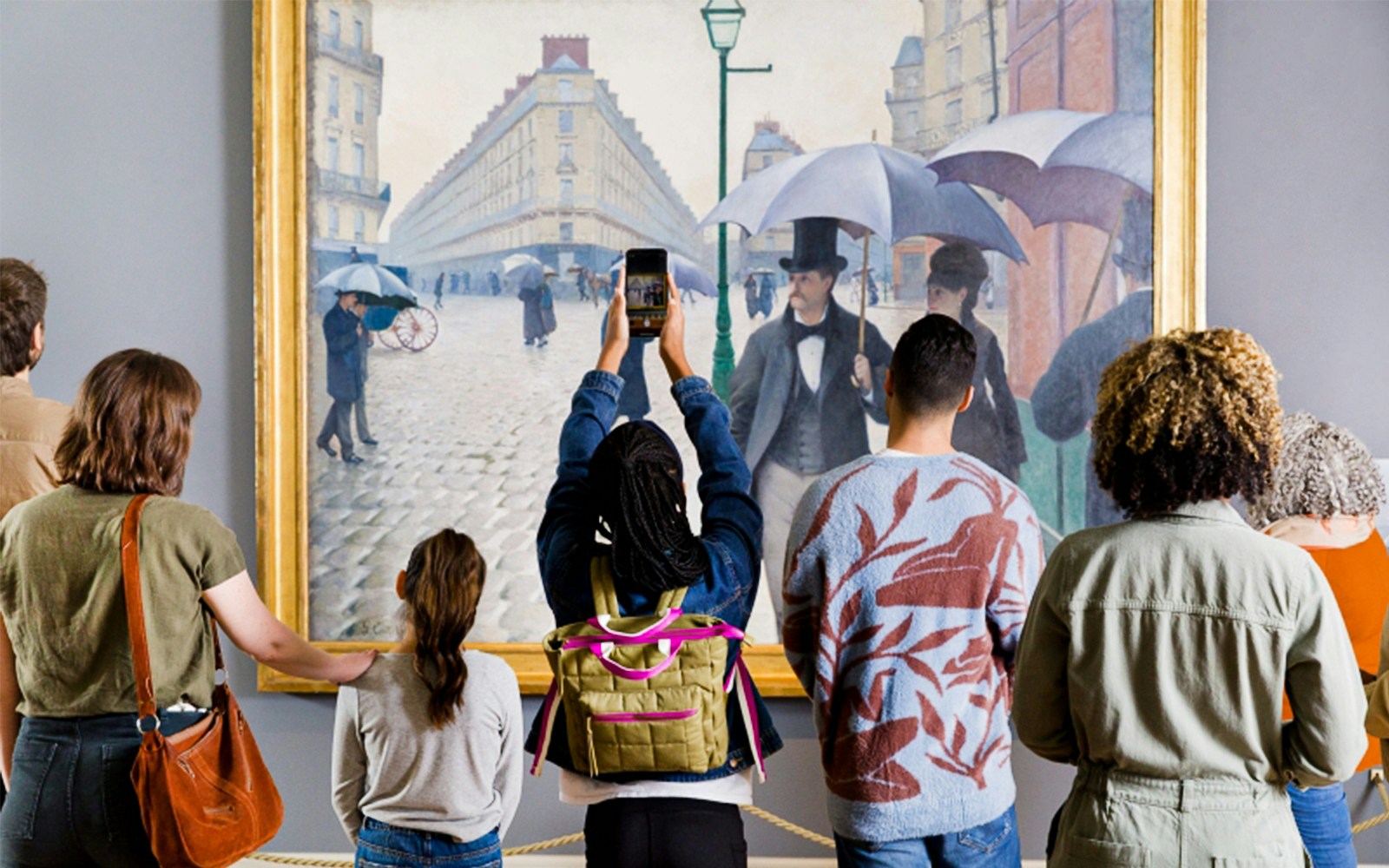 Visitors viewing a painting at The Art Institute of Chicago exhibit.