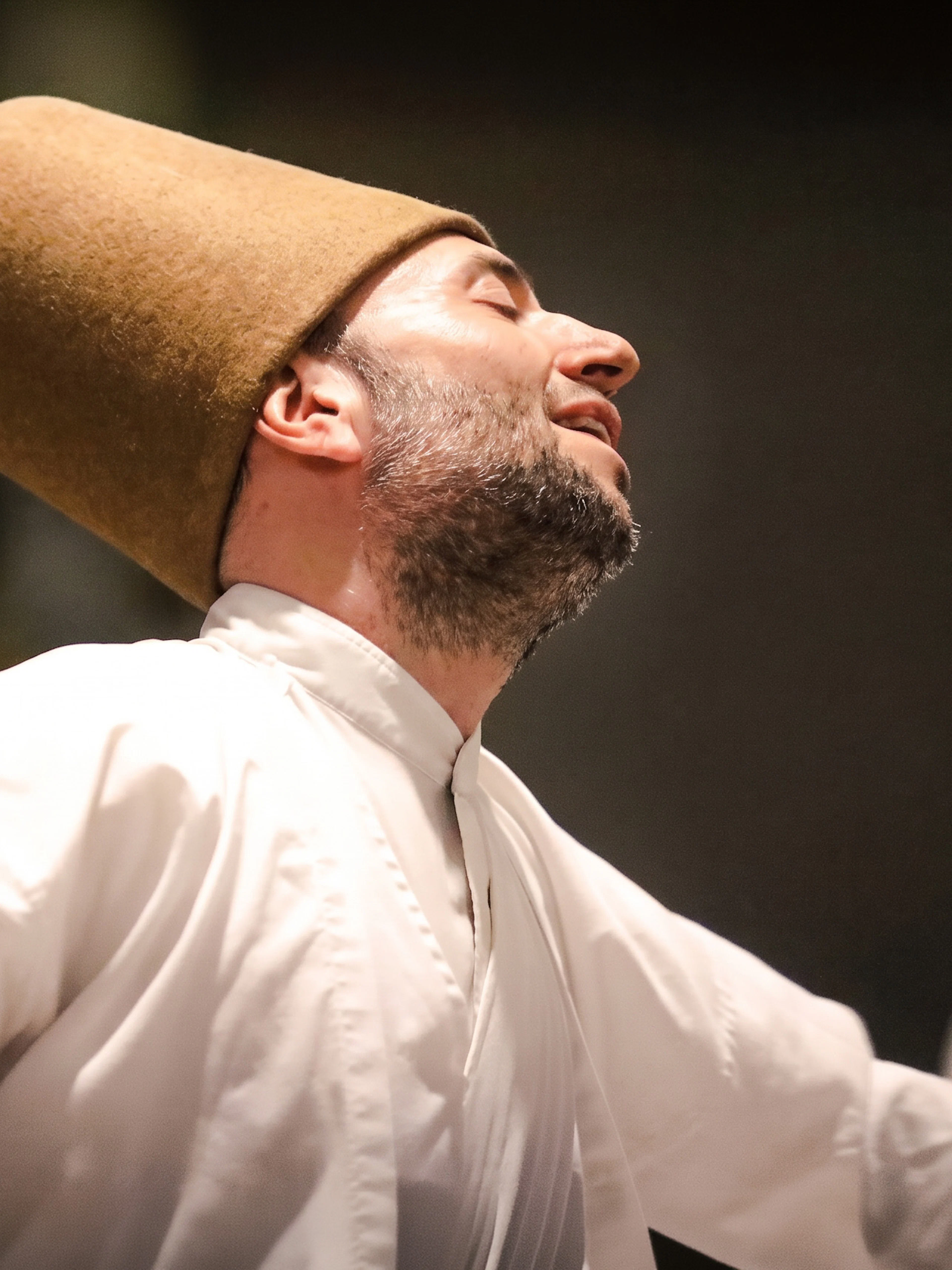 Whirling Dervish performing in traditional attire during a ceremony in Istanbul.