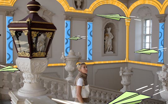 Visitor admiring ornate architecture in a historic building with statues and decorative columns.