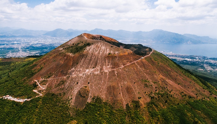 Mount Vesuvius overlooking Naples, Italy, with a clear sky.
