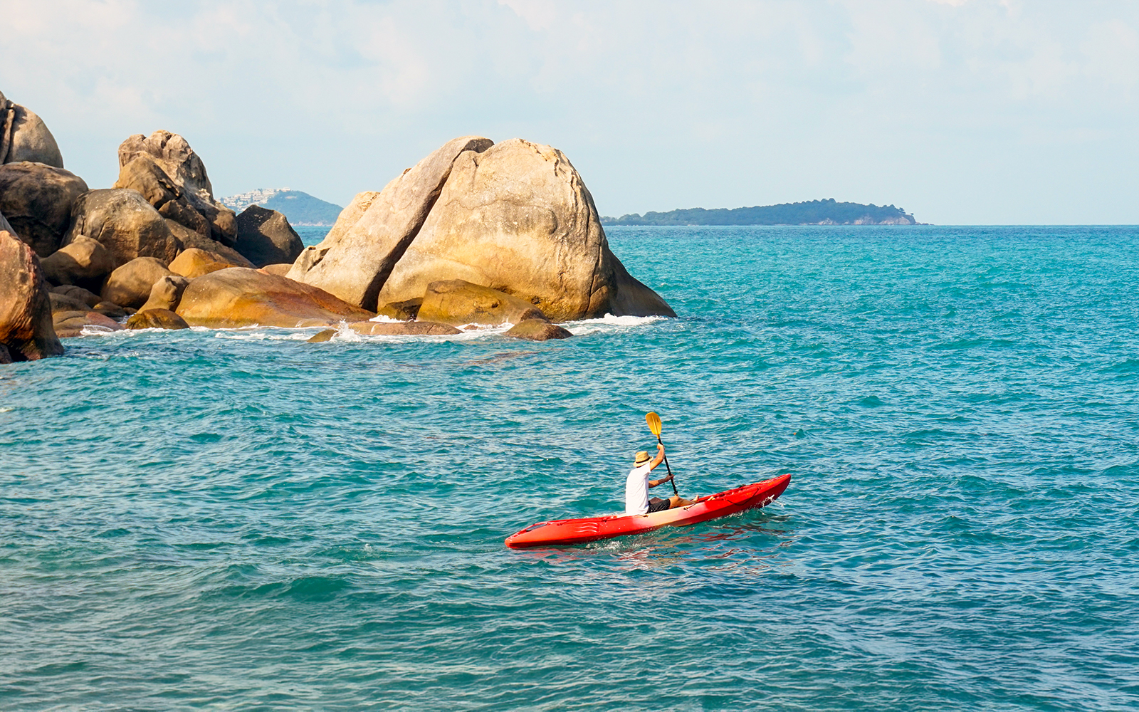 Kayakers paddling near Cape Otway lighthouse, Australia, with scenic coastal views.