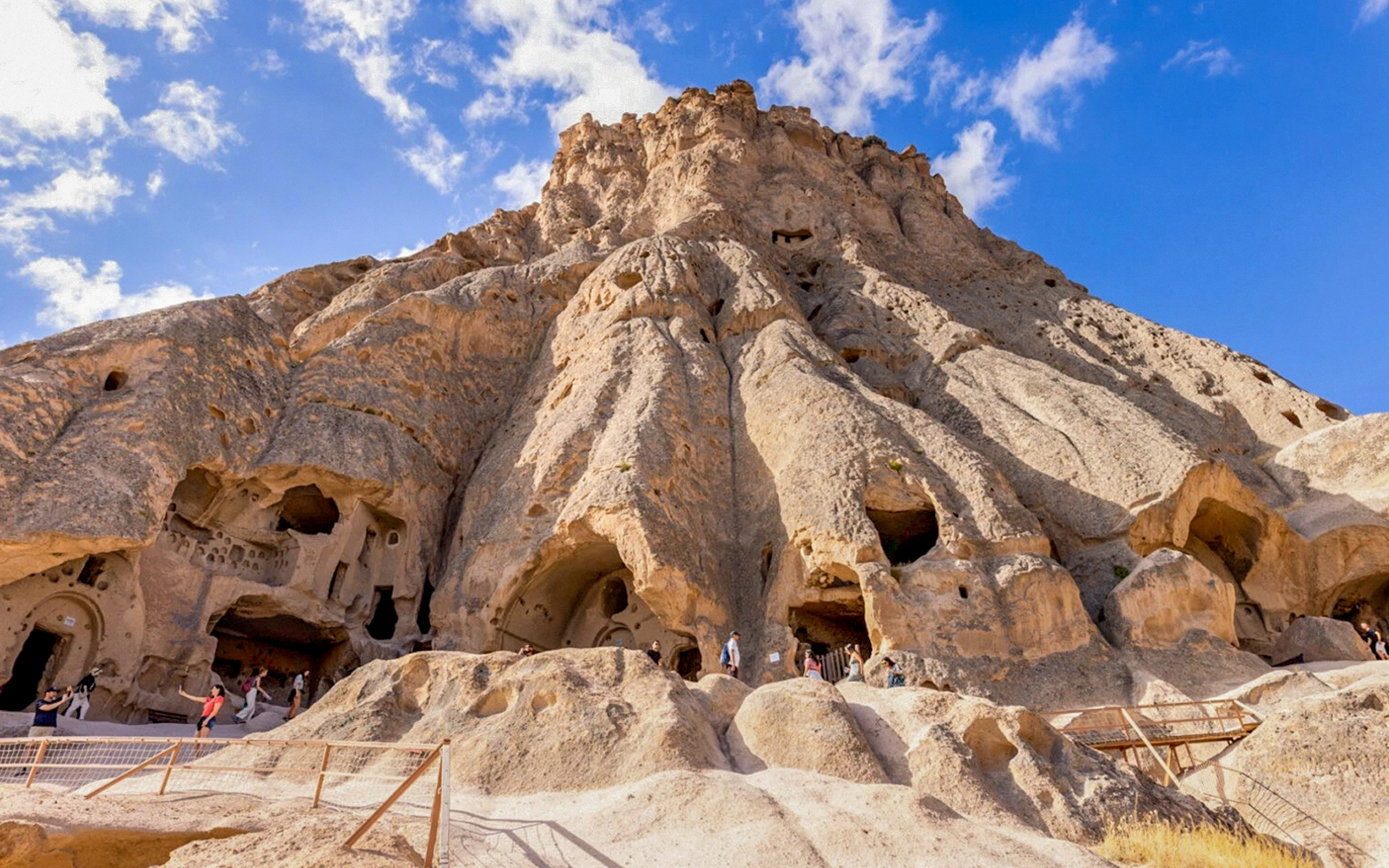 Selime Monastery rock formations with visitors in Cappadocia, Turkey.