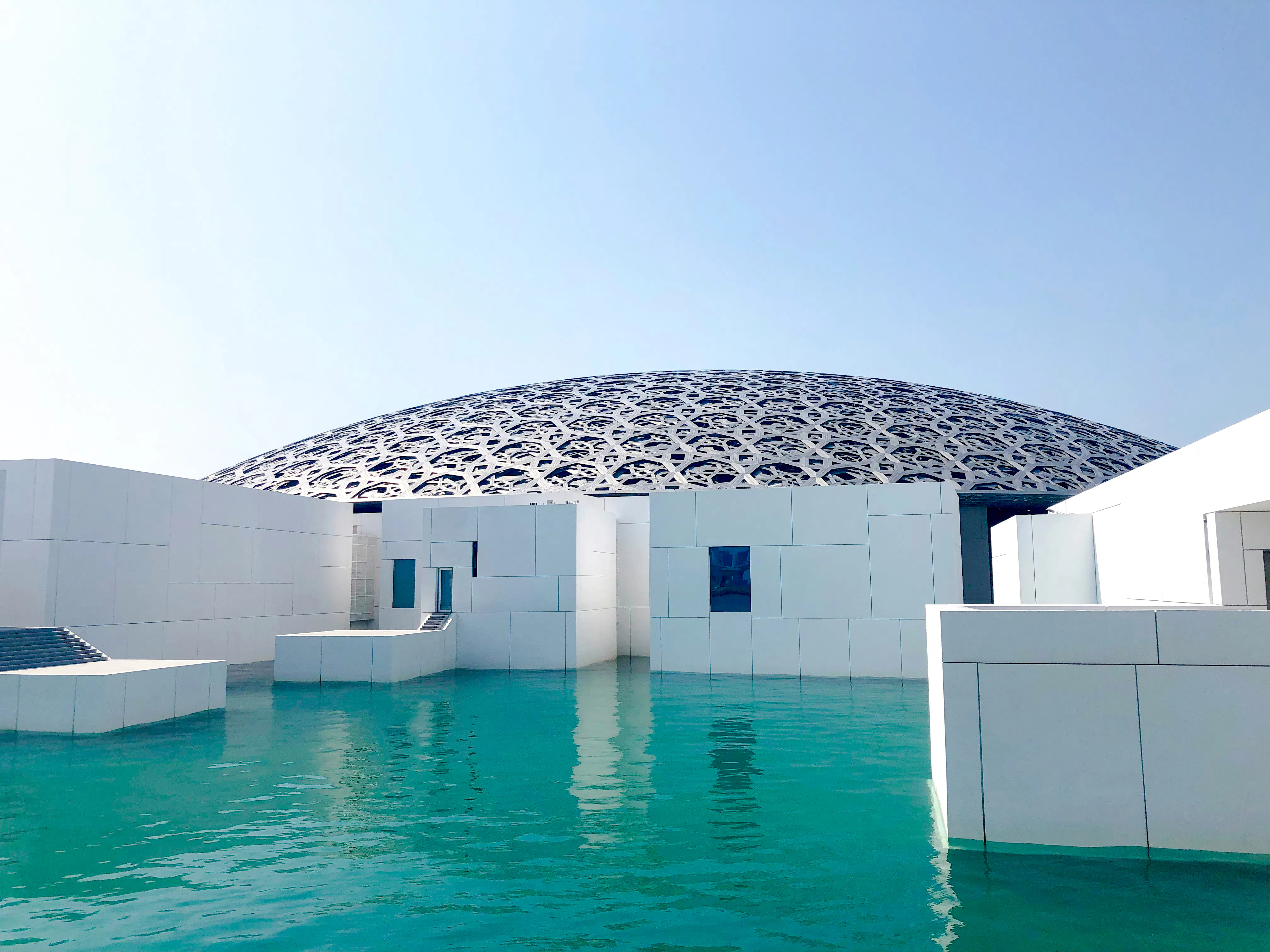 Louvre Abu Dhabi dome and water feature on sightseeing tour from Dubai.