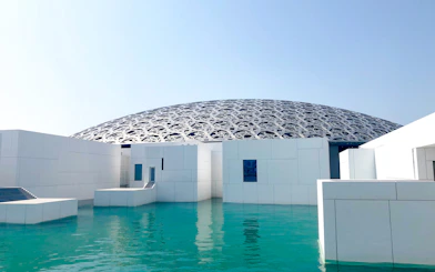 Louvre Abu Dhabi dome and water feature on sightseeing tour from Dubai.