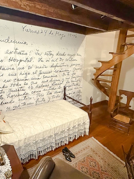 Replica bedroom in Museo Casa Kahlo, Mexico City, with Frida Kahlo's handwritten letter on the wall.
