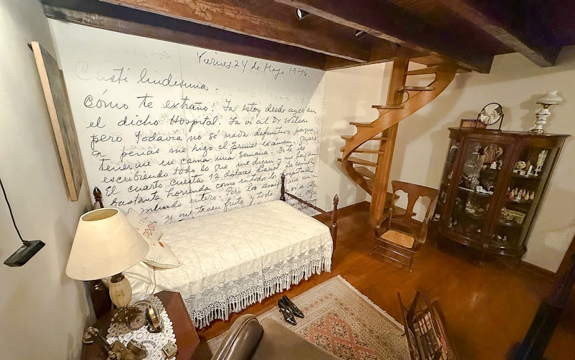 Replica bedroom in Museo Casa Kahlo, Mexico City, with Frida Kahlo's handwritten letter on the wall.