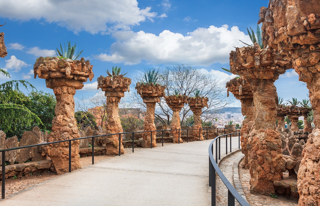 Park Güell mosaic benches with Sagrada Familia in the background, Barcelona.