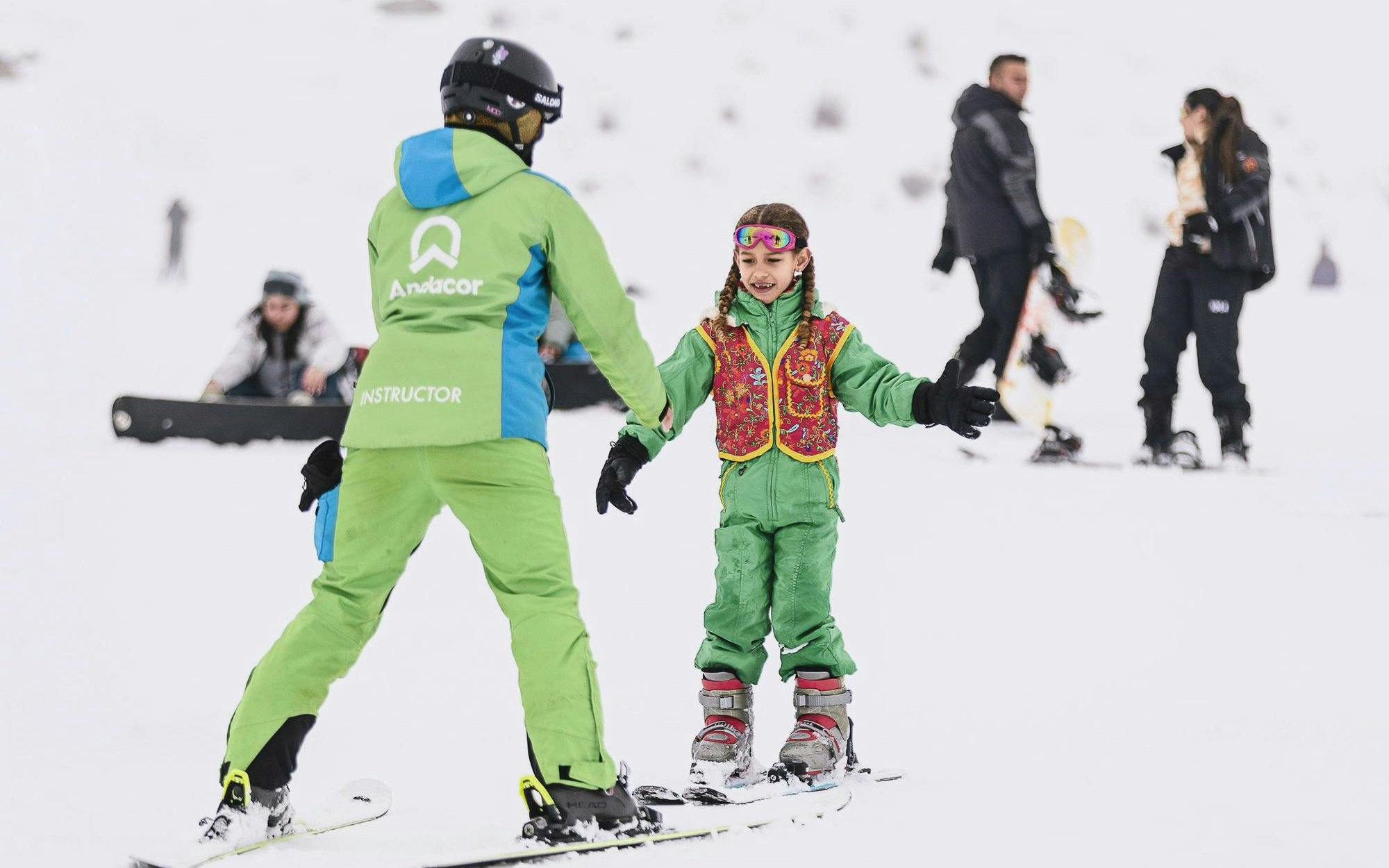Guide teaching child to ski at El Colorado Ski resort.