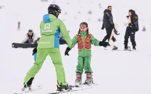 Guide teaching child to ski at El Colorado Ski resort.