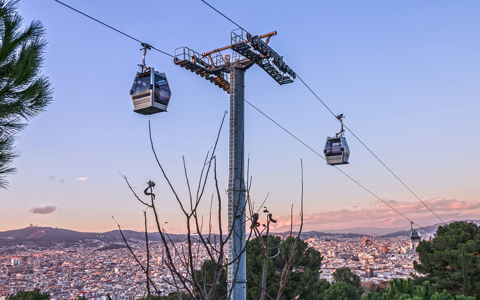 Montjuic Cable Car overlooking Barcelona cityscape and Aquarium Barcelona entrance.