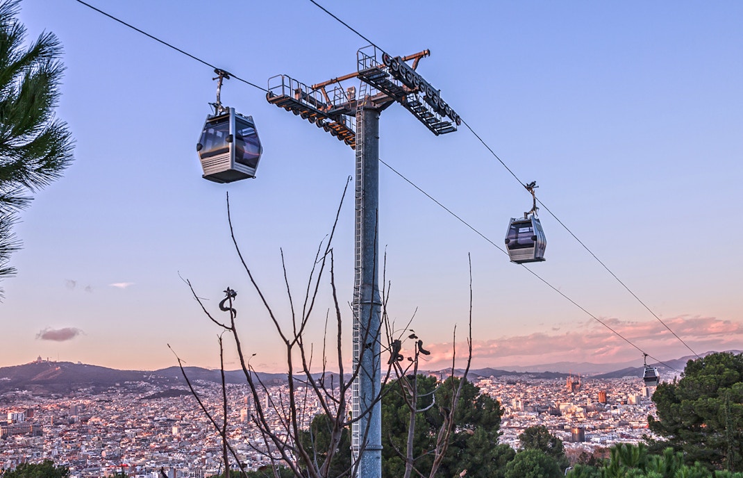 Montjuic Cable Car overlooking Barcelona cityscape and Aquarium Barcelona entrance.