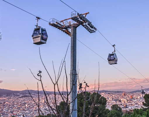 Montjuic Cable Car overlooking Barcelona cityscape and Aquarium Barcelona entrance.