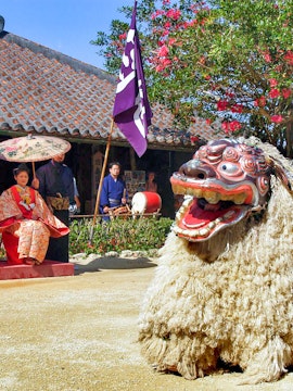 Traditional Ryukyu dance performance with lion costume at Ryukyu Mura, Okinawa.