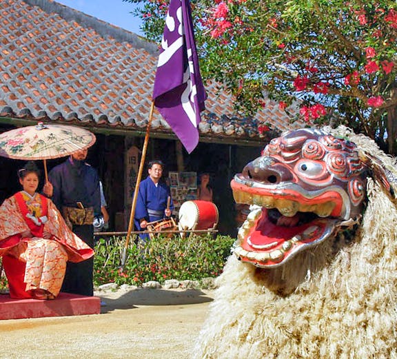 Traditional Ryukyu dance performance with lion costume at Ryukyu Mura, Okinawa.