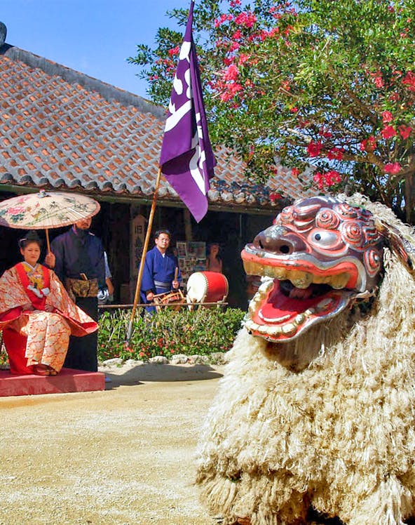Traditional Ryukyu dance performance with lion costume at Ryukyu Mura, Okinawa.