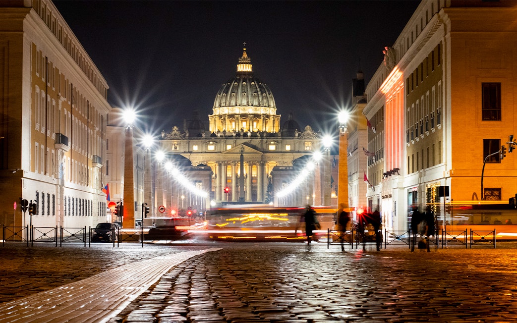 St. Peter's Basilica illuminated at night during Big Bus Rome tour.