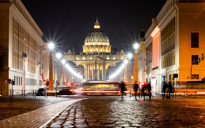 St. Peter's Basilica illuminated at night during Big Bus Rome tour.