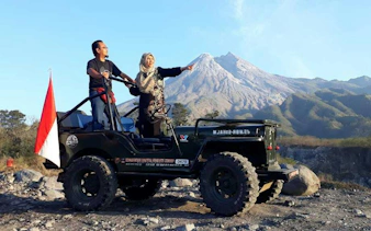 Jeep tour with two people at Mount Merapi, Indonesia, during sunrise.