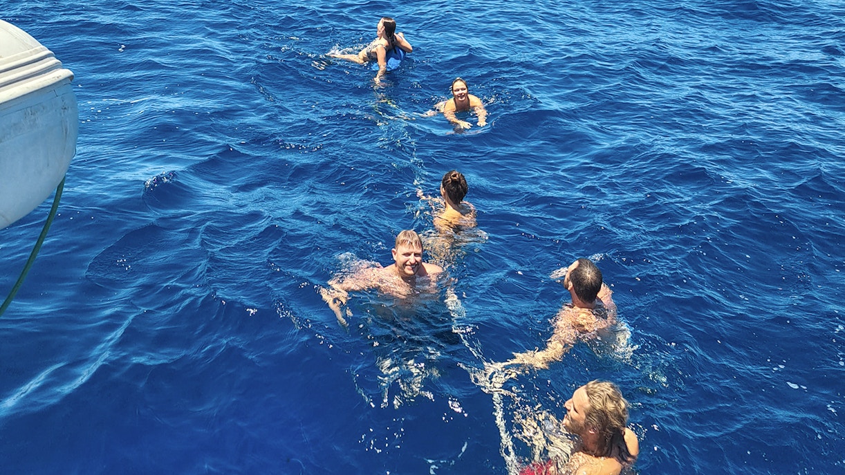 Guests swimming and engaging in water activities during Stavanger Fjord sailing tour.