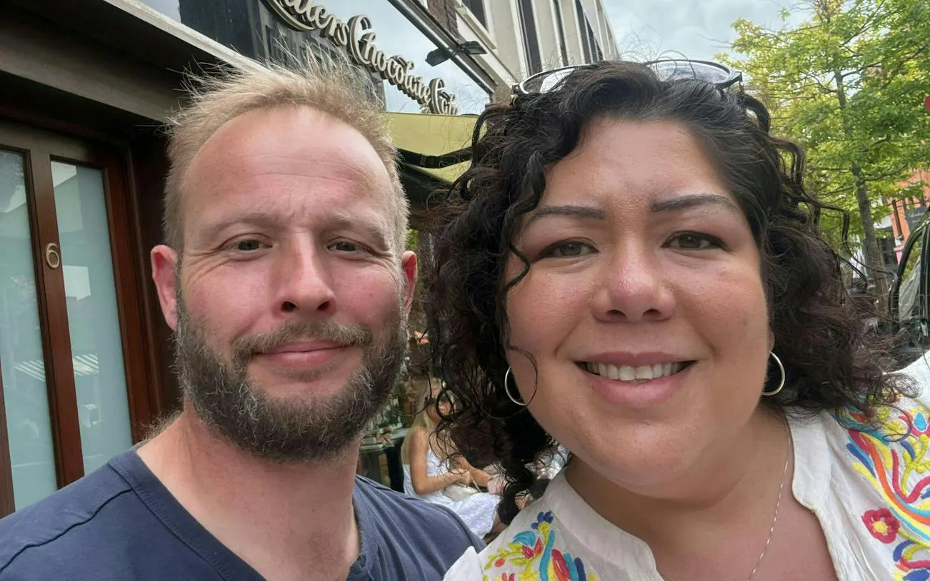Two people smiling outside a café in Dublin during a murder mystery city exploration game.