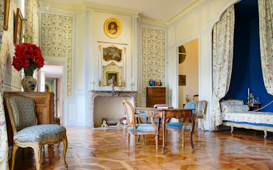 Elegant interior of Château of Villandry with antique furniture and floral decor.