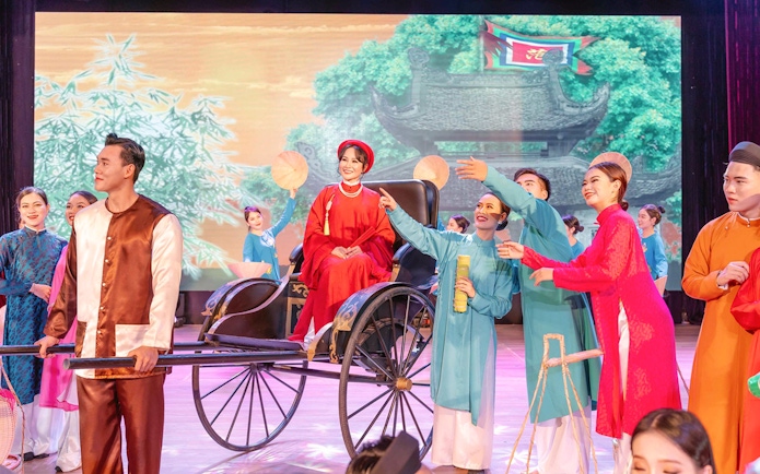 Performers in traditional Vietnamese attire during Ao Dai Show in Da Nang.