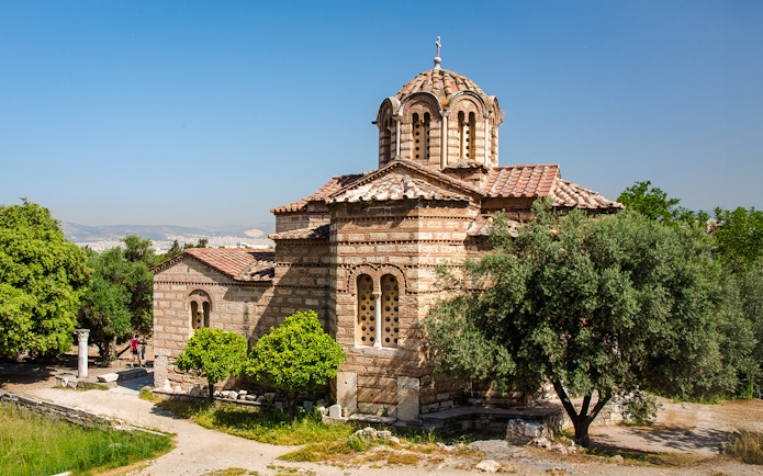 Church of the Holy Apostles in Athens surrounded by trees and ancient ruins.
