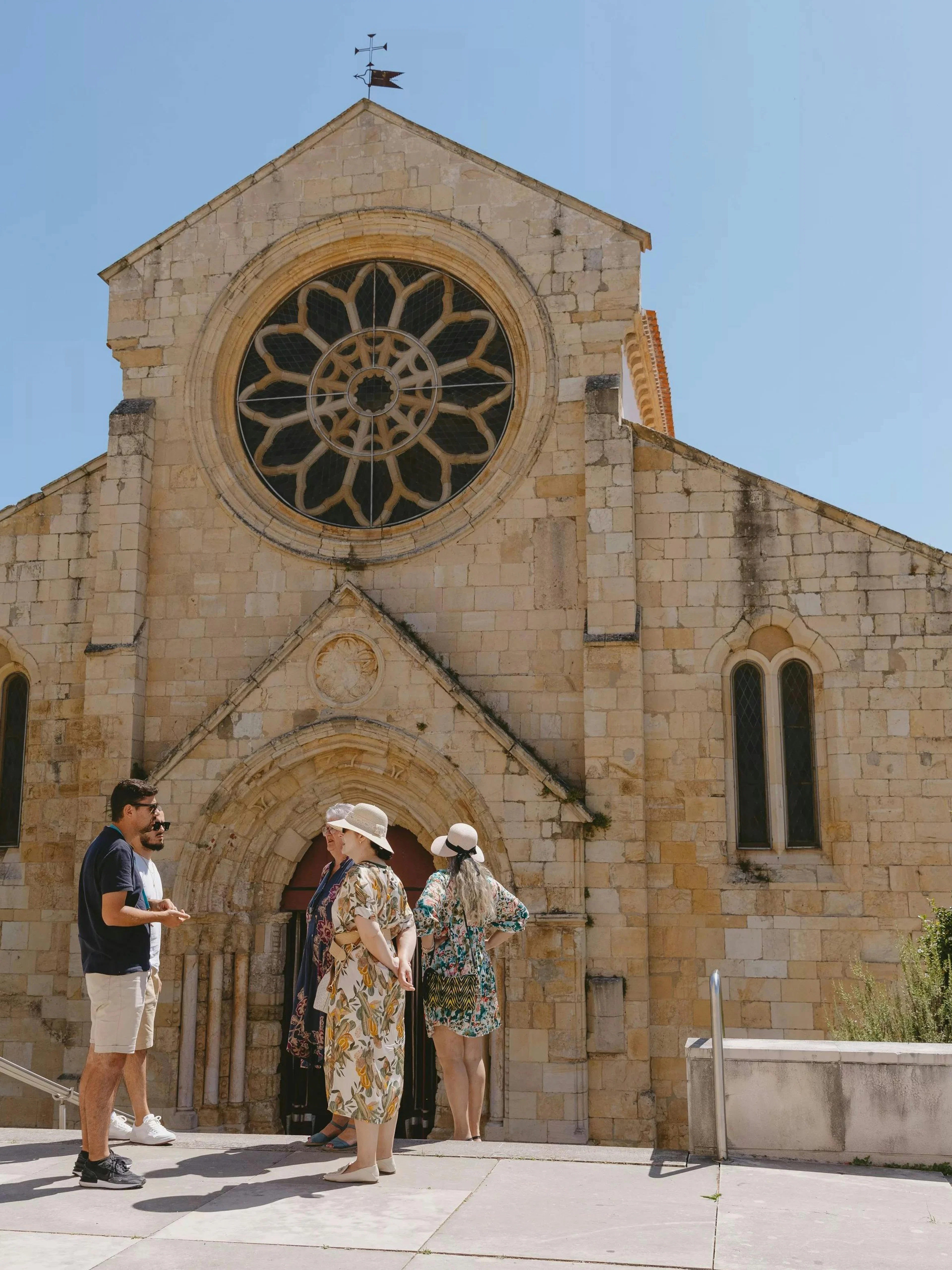 Guide with tourists at Church of Santa Maria do Olival, Tomar, Portugal.