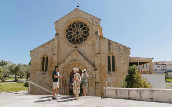 Guide with tourists at Church of Santa Maria do Olival, Tomar, Portugal.