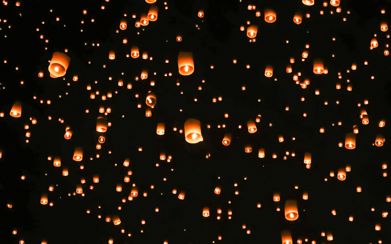 Yipeng Lantern Festival sky filled with glowing lanterns in Chiang Mai, Thailand.