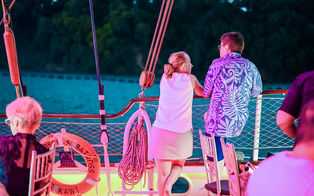 Couple enjoying the view from a cruise ship deck at sunset.