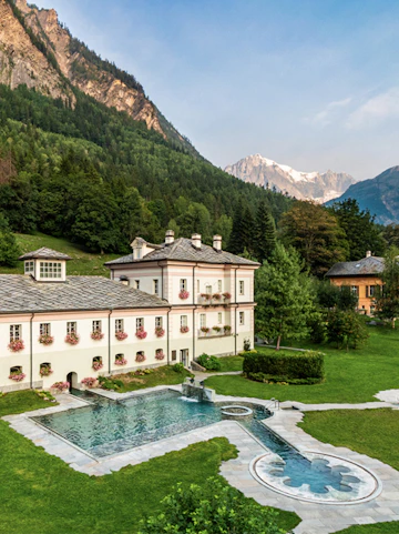 QC Terme Prè Saint Didier spa with mountain backdrop and outdoor pool.