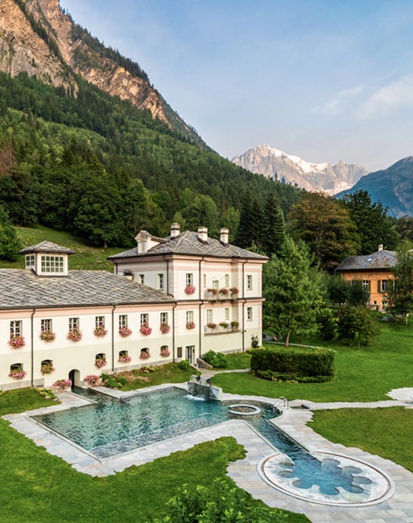 QC Terme Prè Saint Didier spa with mountain backdrop and outdoor pool.