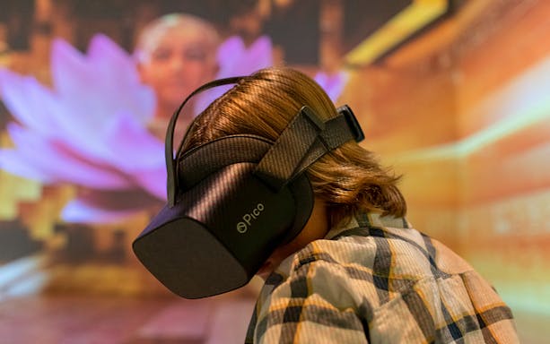 Person experiencing Tutanchamun immersive exhibition with VR headset.
