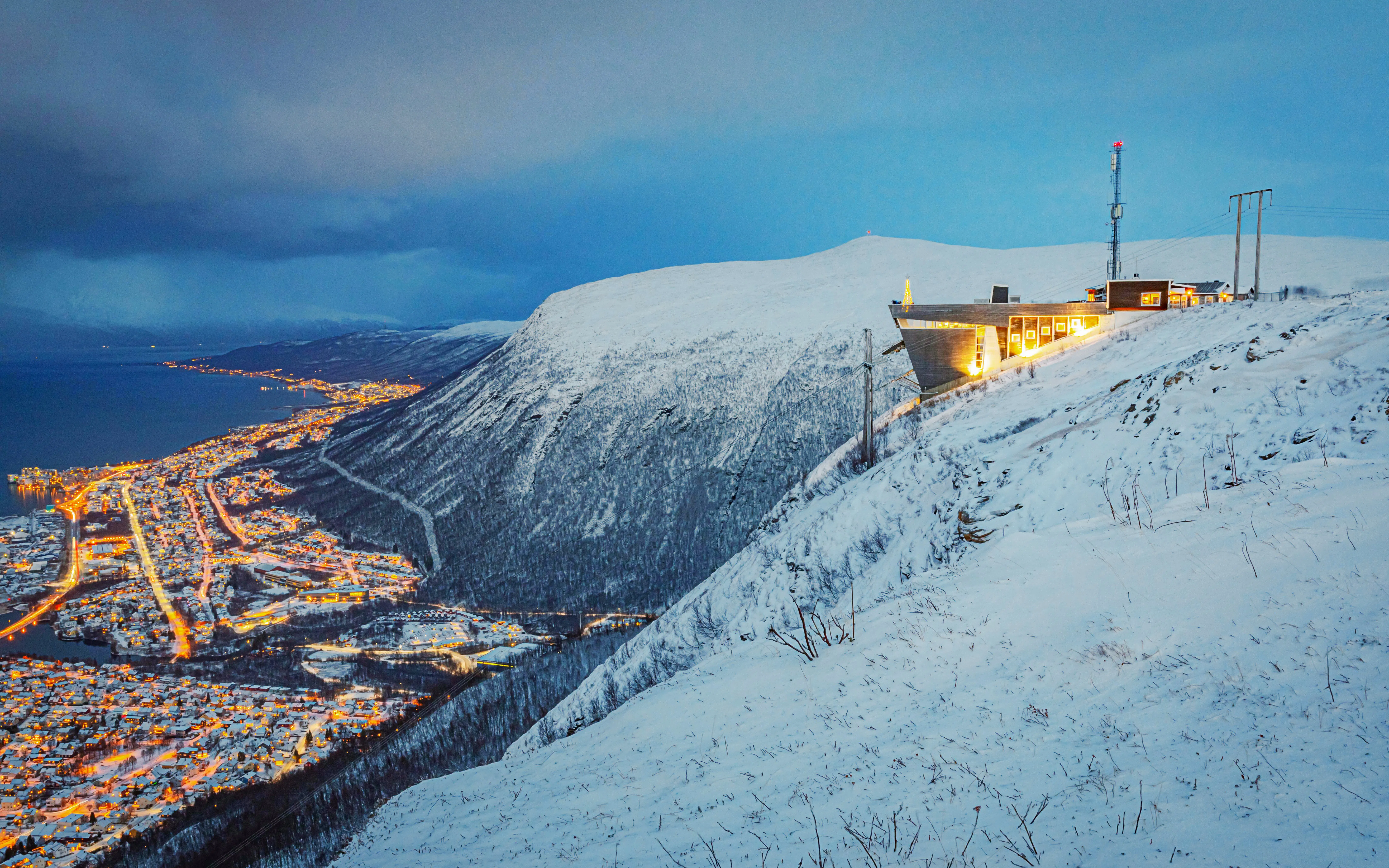 Observation deck on Storsteinen mountain overlooking Tromsø city lights, accessed by Fjellheisen Cable Car.