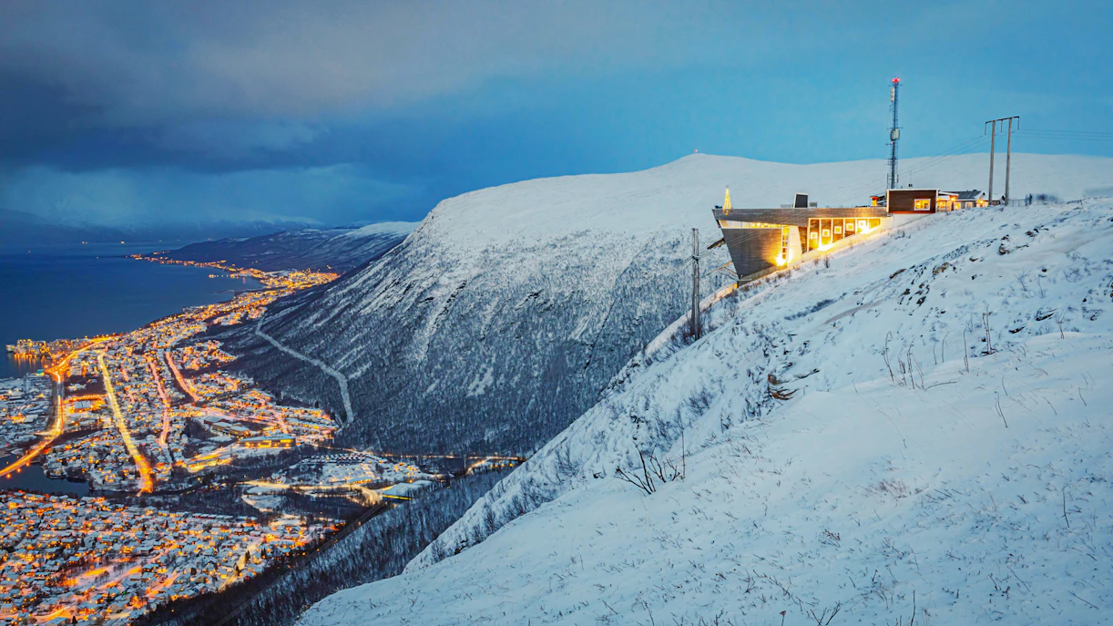 Observation deck on Storsteinen mountain overlooking Tromsø city lights, accessed by Fjellheisen Cable Car.