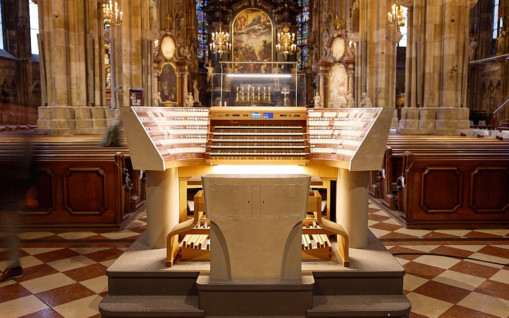 St. Stephen's Cathedral organ console in Vienna, Austria, with ornate interior details.