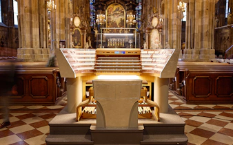 St. Stephen's Cathedral organ console in Vienna, Austria, with ornate interior details.