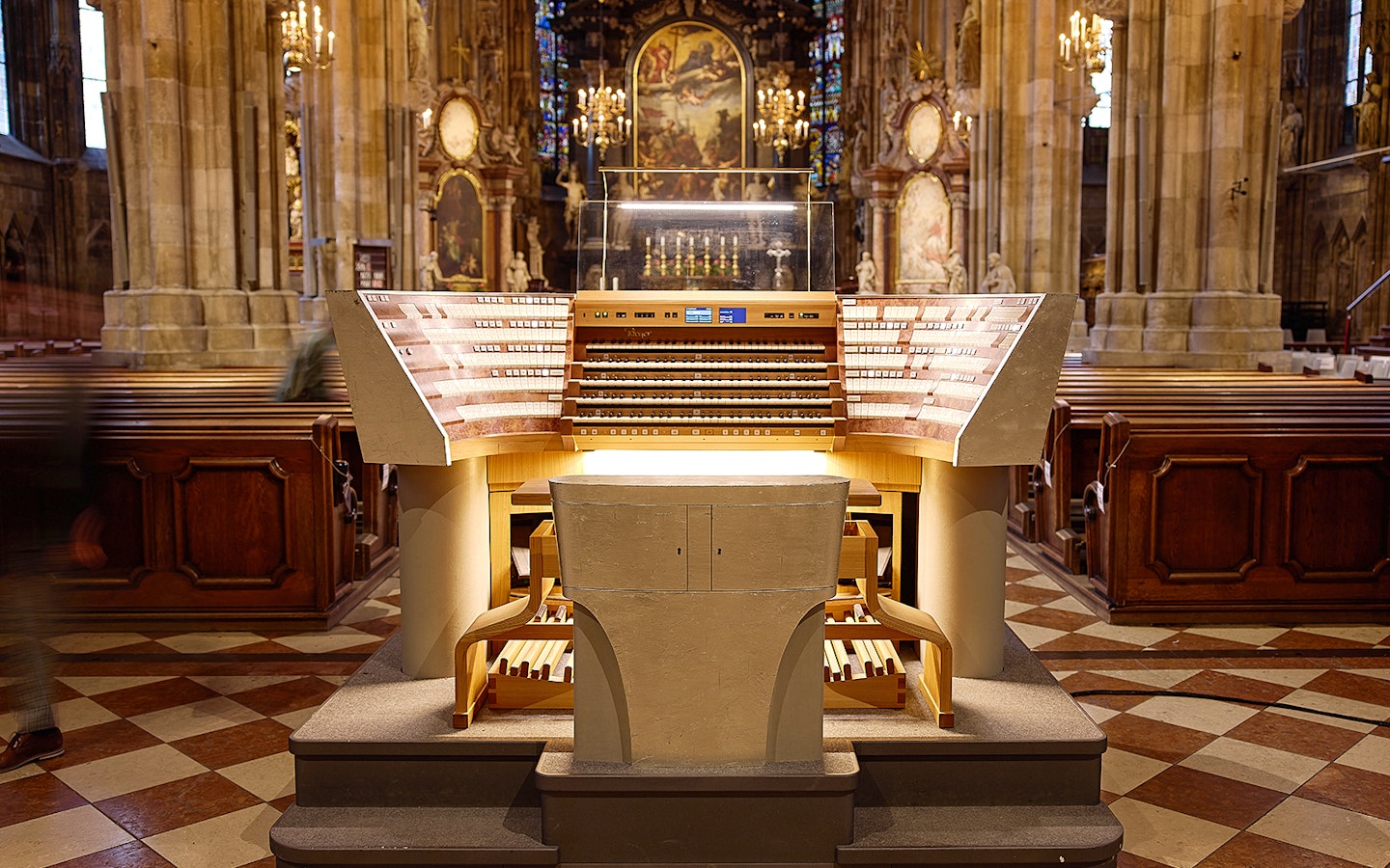 St. Stephen's Cathedral organ console in Vienna, Austria, with ornate interior details.